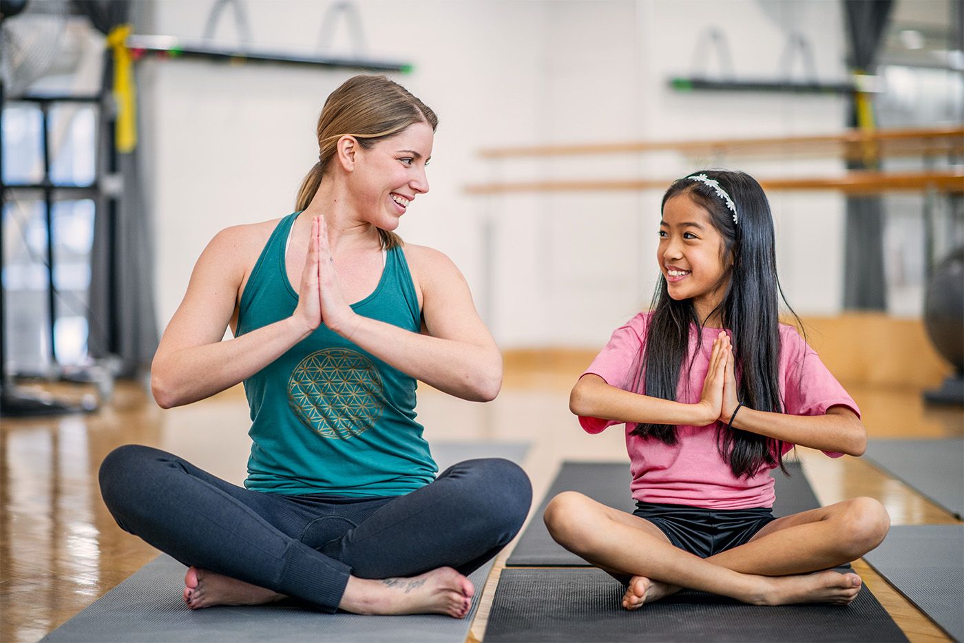 Children's yoga teacher with student